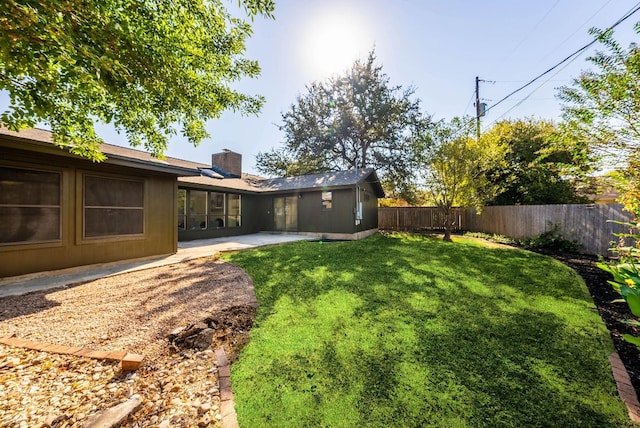 view of yard featuring a patio and a fenced backyard