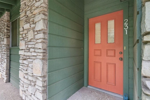 doorway to property with stone siding