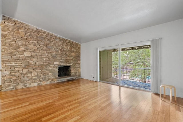 1304 Mariposa Dr Unit 231, Austin, TX 78704 - unfurnished living room featuring wood finished floors, lofted ceiling, and a fireplace