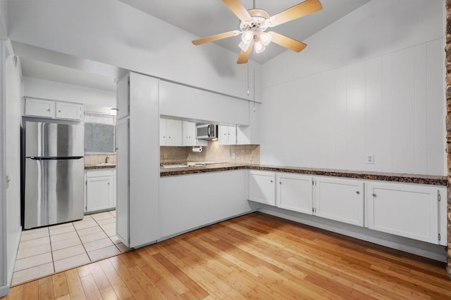 kitchen featuring light wood-style flooring, appliances with stainless steel finishes, white cabinets, and ceiling fan