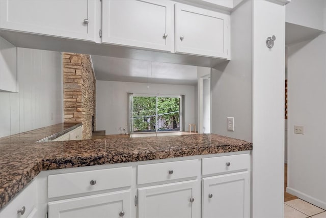 kitchen featuring light tile patterned floors and white cabinetry