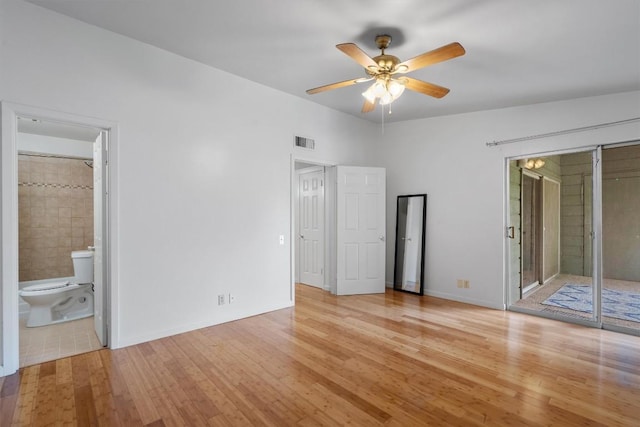 1304 Mariposa Dr Unit 231, Austin, TX 78704 - unfurnished bedroom with light wood-type flooring, baseboards, connected bathroom, and ceiling fan