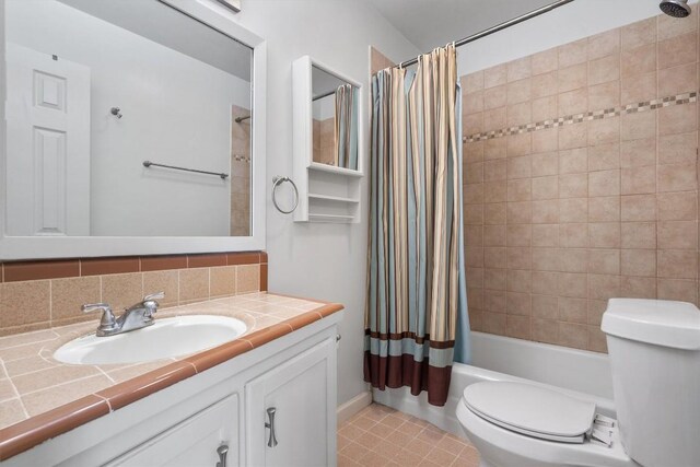 full bath featuring vanity, tile patterned floors, toilet, and shower / tub combo