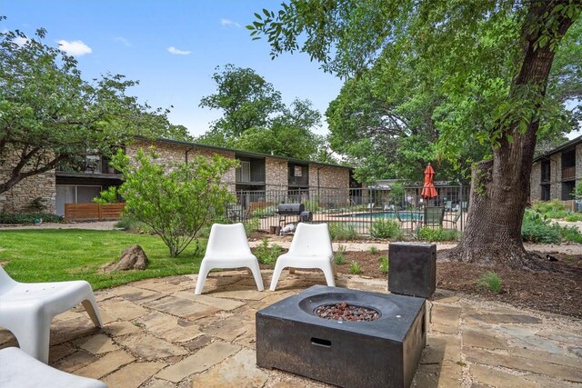 view of patio / terrace with fence and an outdoor fire pit