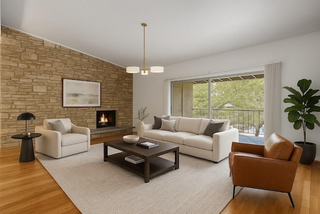 1304 Mariposa Dr Unit 231, Austin, TX 78704 - living area featuring light wood-style floors, vaulted ceiling, and a stone fireplace