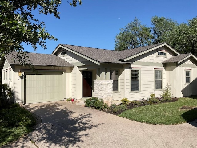 13604 Caldwell Dr Unit 72, Austin, TX 78750 - view of front of home with a shingled roof, concrete driveway, an attached garage, and board and batten siding