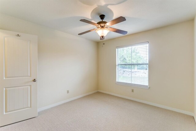 unfurnished room featuring baseboards, ceiling fan, and light carpet