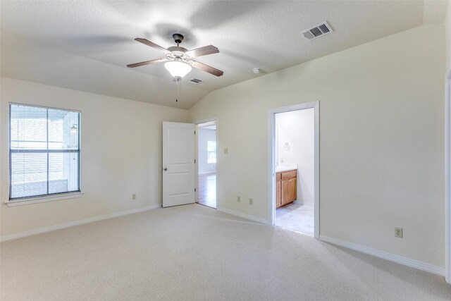 unfurnished bedroom featuring baseboards, light carpet, and visible vents