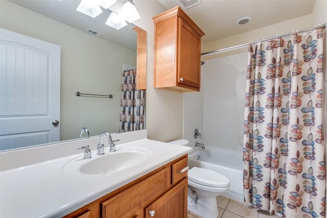bathroom with tile patterned flooring, shower / tub combo with curtain, toilet, a skylight, and visible vents
