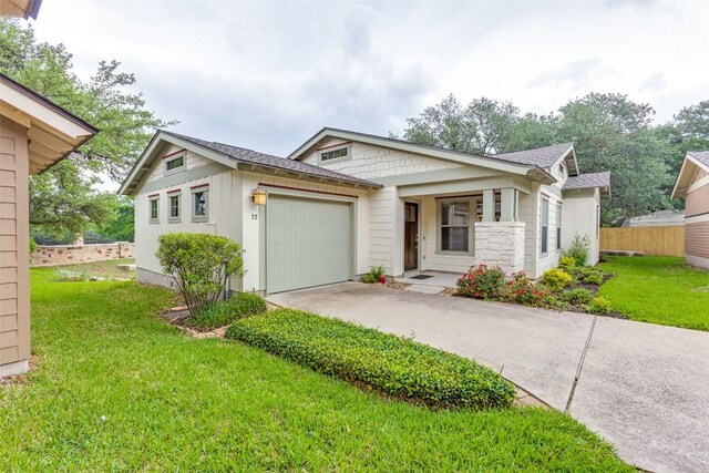 view of front of property featuring a garage, fence, a front lawn, concrete driveway, and a shingled roof