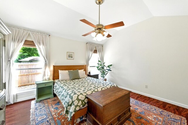 bedroom featuring baseboards, ceiling fan, wood finished floors, and lofted ceiling