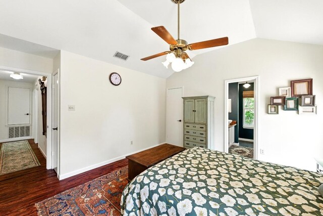 bedroom featuring visible vents, wood finished floors, and vaulted ceiling