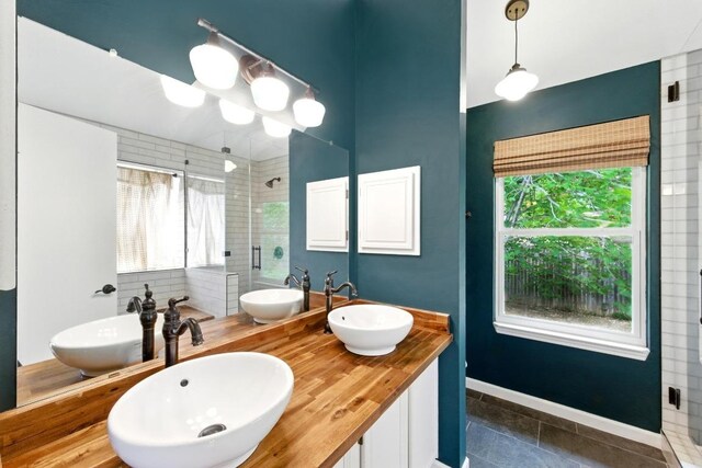 bathroom with a sink and a shower stall