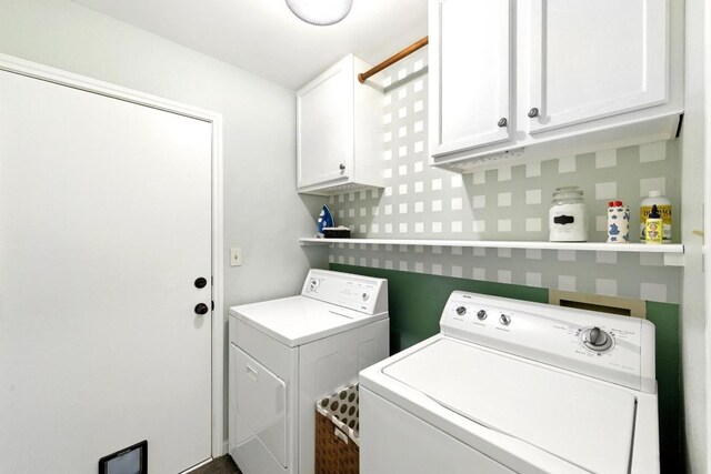 laundry area featuring independent washer and dryer and cabinet space