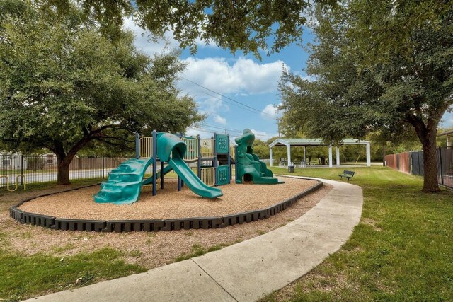 communal playground with a lawn and fence