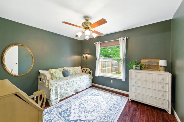 bedroom featuring baseboards, a ceiling fan, and wood finished floors
