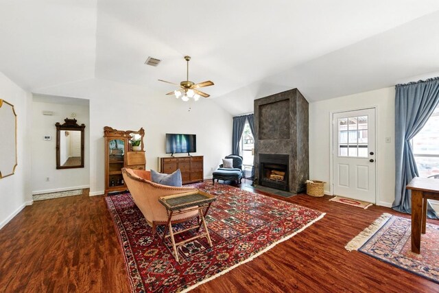 living room with vaulted ceiling, wood finished floors, and a wealth of natural light