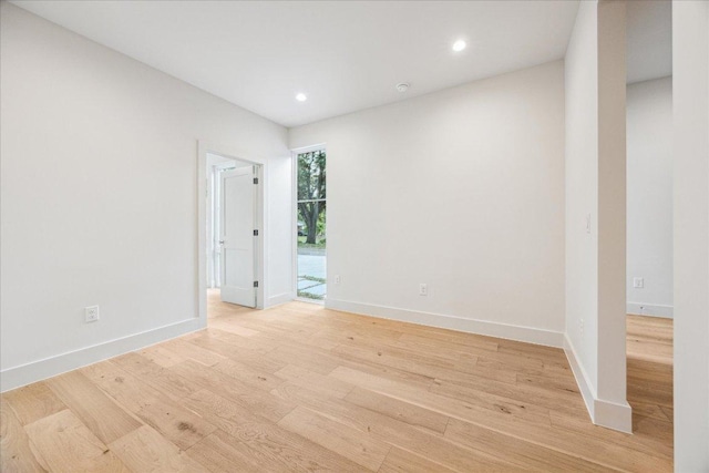unfurnished room featuring recessed lighting, baseboards, and light wood-style flooring
