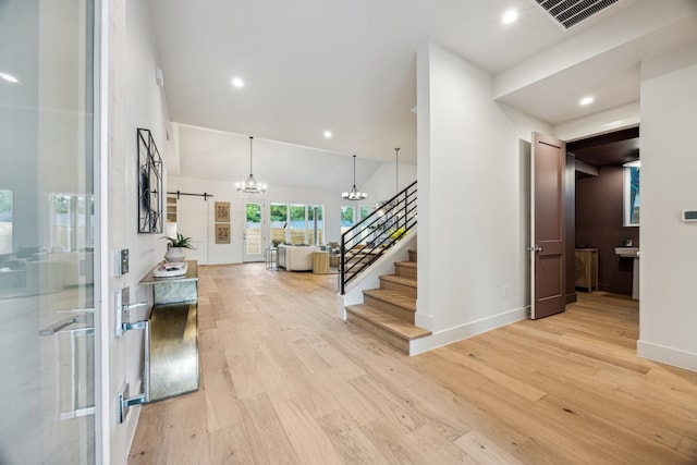 4708 Philco Dr, Austin, TX 78745 - foyer with a chandelier, light wood finished floors, stairs, a high ceiling, and recessed lighting