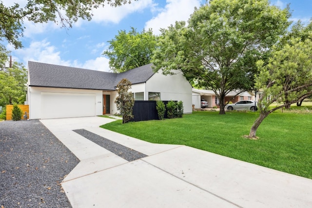 4708 Philco Dr, Austin, TX 78745 - view of front of house featuring concrete driveway, a garage, a front lawn, and stucco siding