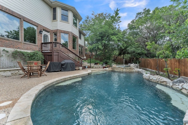 view of swimming pool with a grill, a patio, a fenced backyard, a fenced in pool, and an in ground hot tub