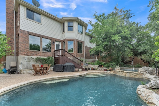 10636 Bramblecrest Dr, Austin, TX 78726 - back of house with brick siding, a patio area, and a pool with connected hot tub