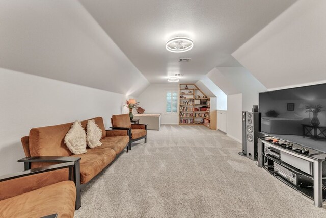 living room featuring carpet floors, lofted ceiling, and visible vents