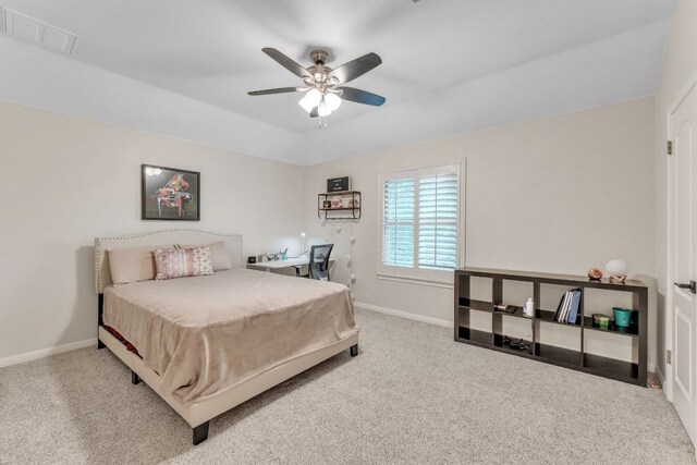 carpeted bedroom featuring baseboards, a ceiling fan, and visible vents