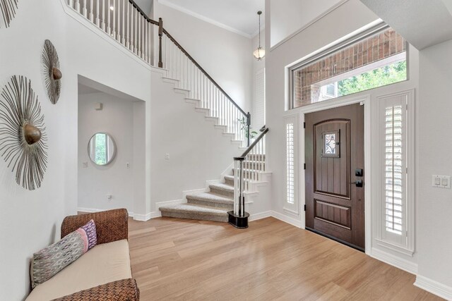 entryway featuring a healthy amount of sunlight, light wood-style flooring, and stairway