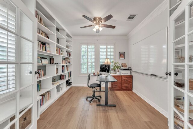 office with a ceiling fan, visible vents, baseboards, ornamental molding, and light wood-style flooring