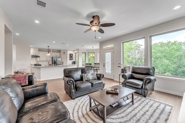 10636 Bramblecrest Dr, Austin, TX 78726 - living area featuring a ceiling fan, healthy amount of natural light, light wood-style flooring, and recessed lighting