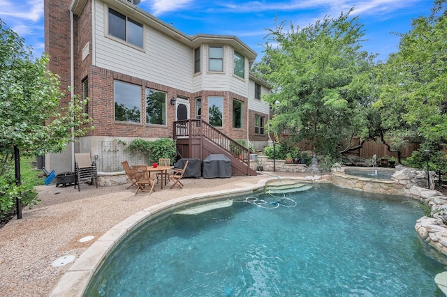 10636 Bramblecrest Dr, Austin, TX 78726 - rear view of house featuring a patio area, brick siding, and a pool with connected hot tub