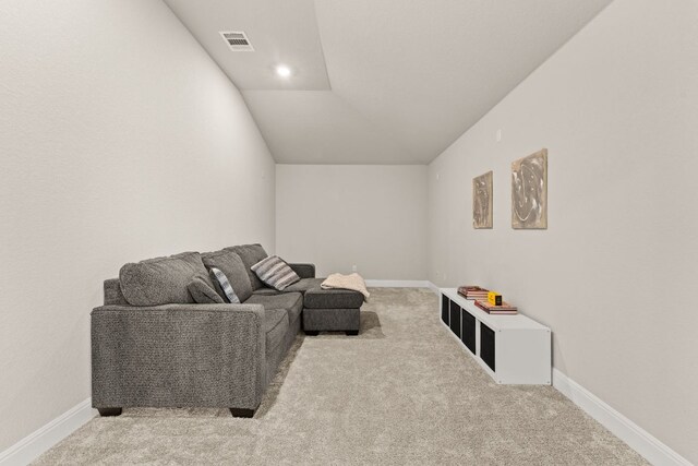 interior space with visible vents, carpet flooring, baseboards, and vaulted ceiling