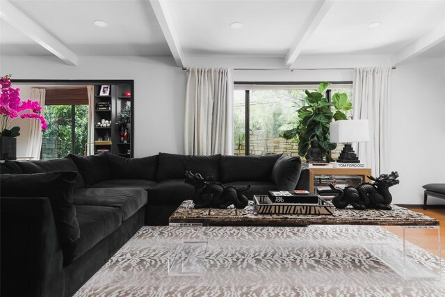 living room with recessed lighting, beam ceiling, and wood finished floors