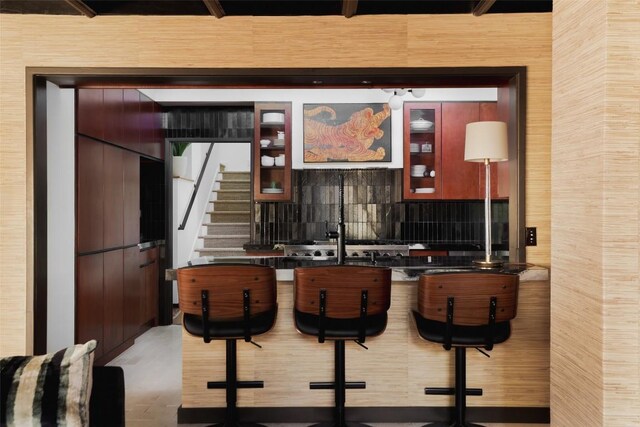 bar with decorative backsplash and stairs