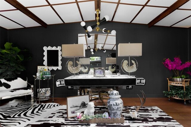 interior space with an inviting chandelier, baseboards, vaulted ceiling, and wood finished floors