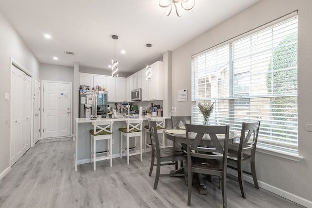 16100 S Great Oaks Dr Unit 3602, Round Rock, TX 78681 - dining area featuring light wood-style flooring and baseboards