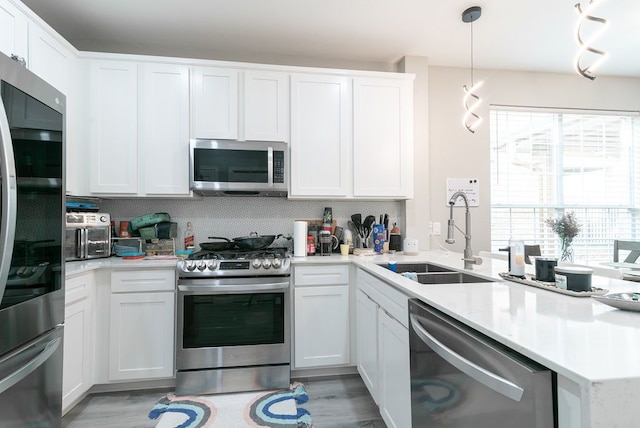 16100 S Great Oaks Dr Unit 3602, Round Rock, TX 78681 - kitchen with appliances with stainless steel finishes, light countertops, white cabinets, and light wood-style floors