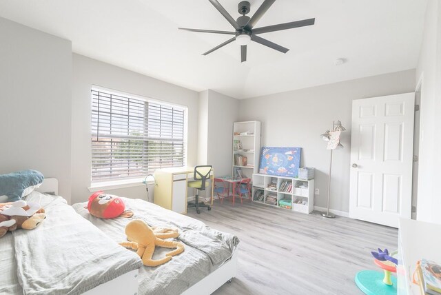 bedroom featuring baseboards, a ceiling fan, and wood finished floors