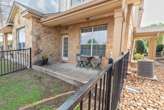 exterior space with a garage and central AC unit