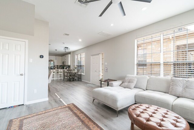 living room with ceiling fan, recessed lighting, baseboards, light wood-type flooring, and visible vents