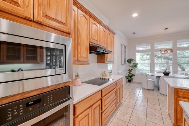 kitchen featuring light countertops, ornamental molding, under cabinet range hood, and stainless steel appliances