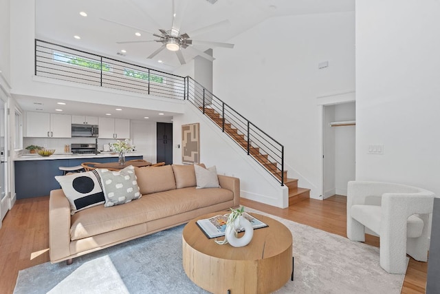 402 W 55th St Unit 2, Austin, TX 78751 - living area featuring light wood-type flooring, stairs, high vaulted ceiling, recessed lighting, and a ceiling fan