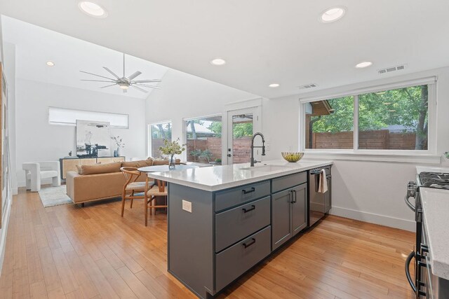 kitchen featuring light countertops, gray cabinetry, appliances with stainless steel finishes, and a sink