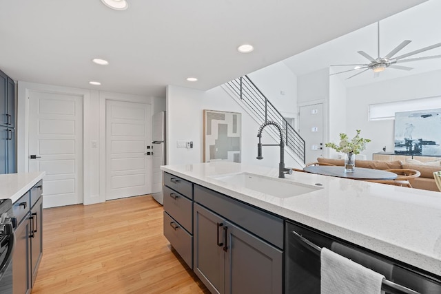 402 W 55th St Unit 2, Austin, TX 78751 - kitchen with a sink, freestanding refrigerator, dishwashing machine, gray cabinetry, and light wood-style floors
