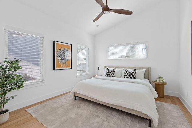 402 W 55th St Unit 2, Austin, TX 78751 - bedroom featuring multiple windows, wood finished floors, vaulted ceiling, and baseboards