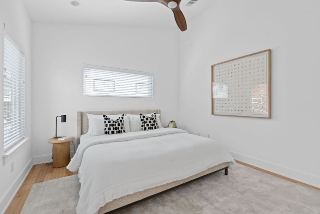 bedroom with baseboards, ceiling fan, and wood finished floors