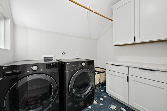 clothes washing area featuring cabinet space and washing machine and clothes dryer