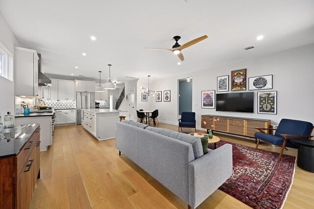 1815 Cullen Ave Unit 1, Austin, TX 78757 - living area featuring light wood finished floors, recessed lighting, ceiling fan, and stairs