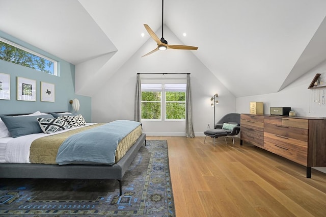 bedroom featuring a ceiling fan, baseboards, vaulted ceiling, and wood finished floors